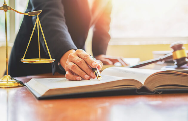 Judge gavel with Justice lawyers having team meeting at law firm background. Concepts of Law and Legal services.